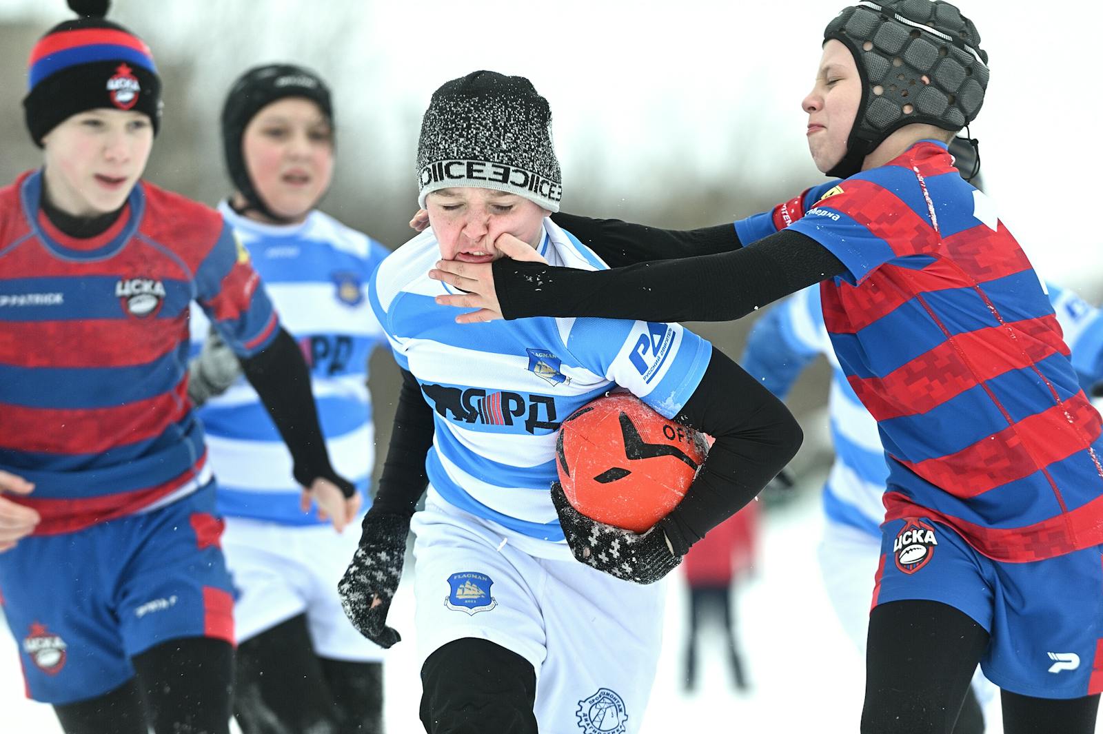 Boys tackling whilst Playing Rugby in Winter