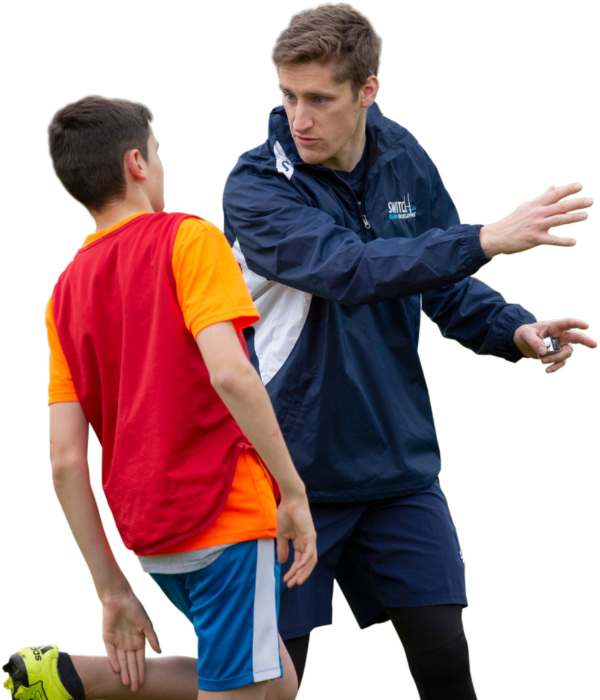 coach helping a young player at a Switch Rugby session