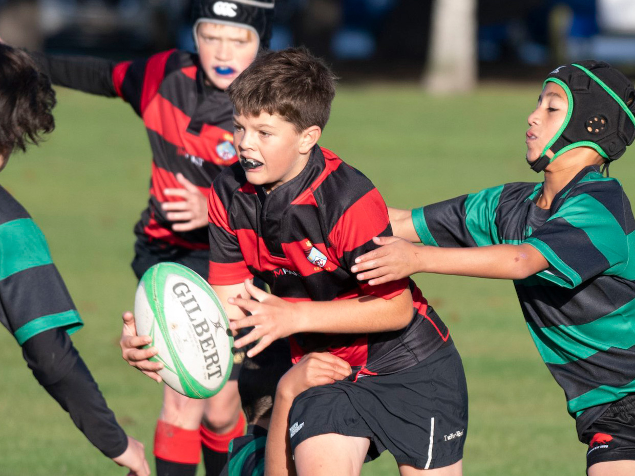 A young player being tackled during a Switch Rugby session