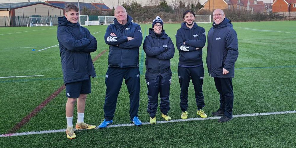 The Switch Rugby line up posing on a pitch.