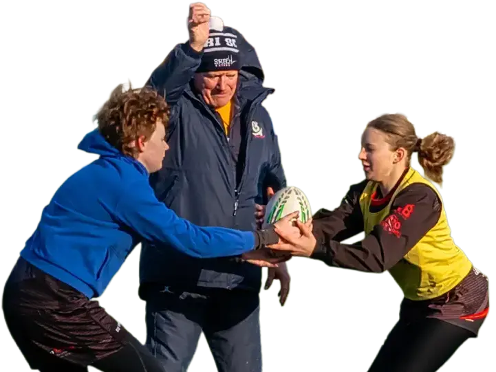 A Switch Rugby coach guiding two young players through a ball-handling drill during a paired coaching session